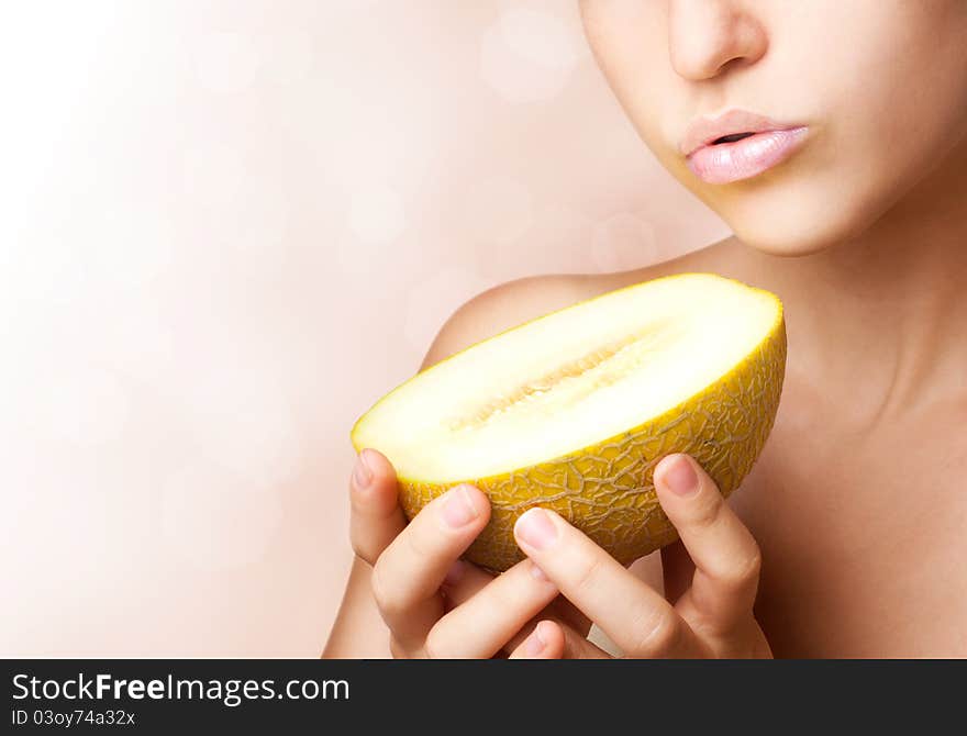 Beautiful woman with melon,close-up