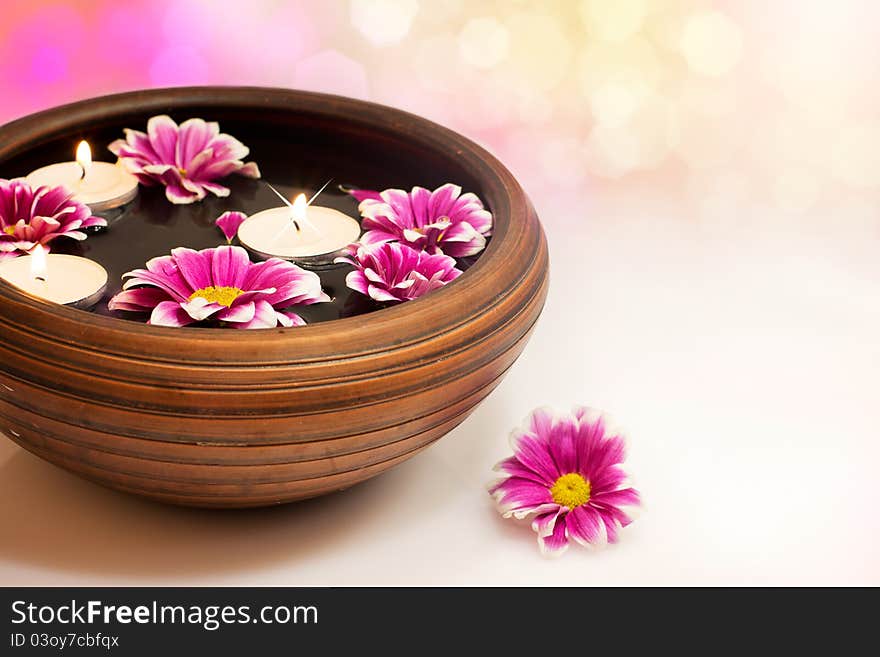 Candles with flowers in water