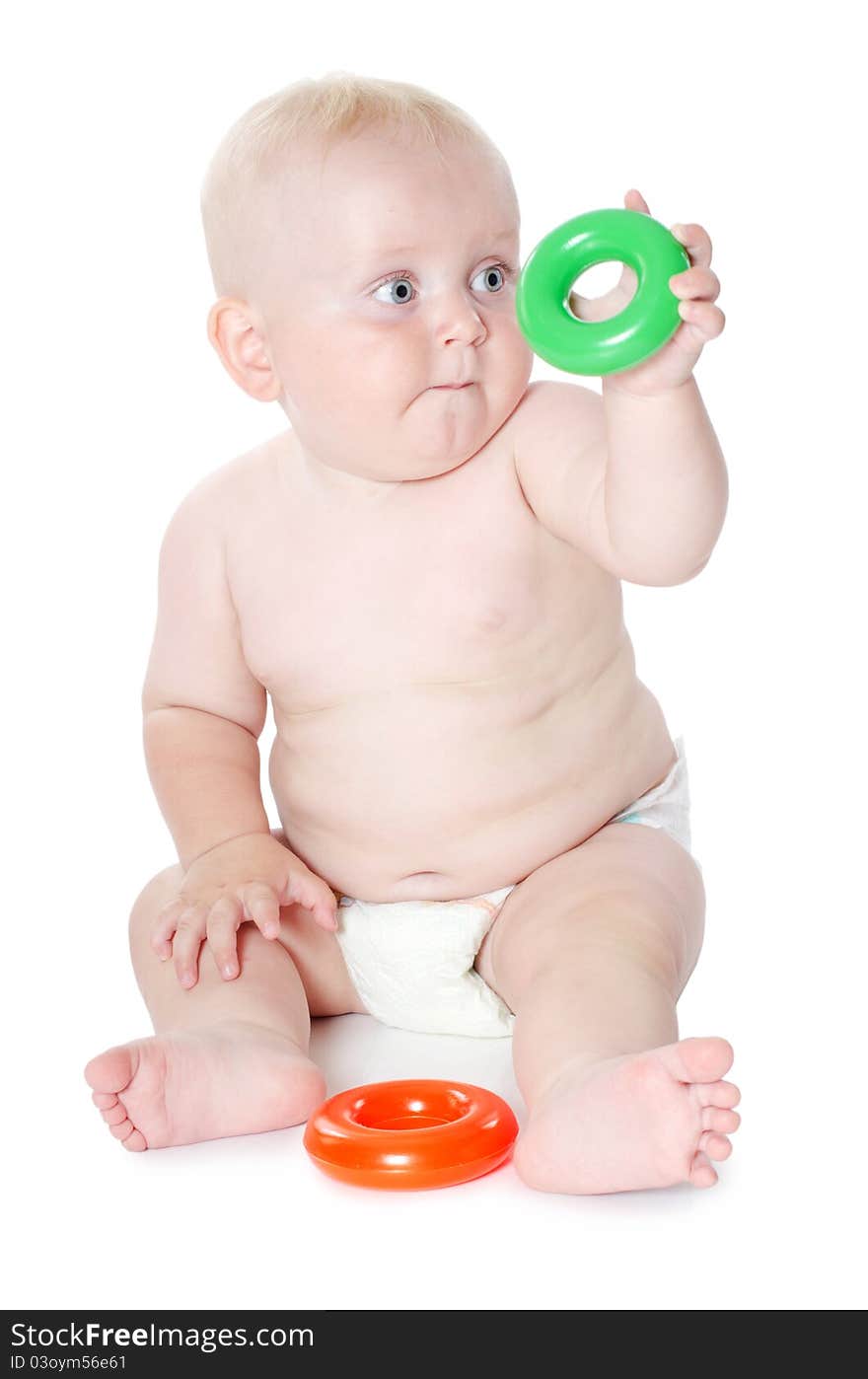 Little baby plays toys isolated on white. Little baby plays toys isolated on white