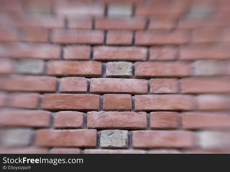 Blurred view of brick wall, center in focus. Blurred view of brick wall, center in focus.