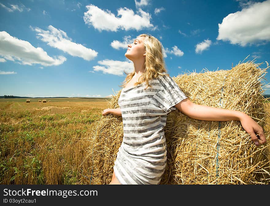 Girl at a stack of straw