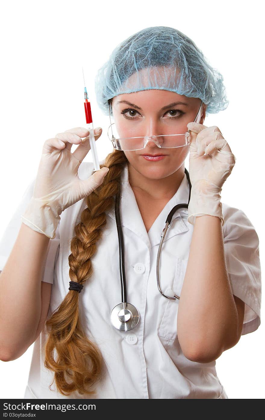 Physician with long hair in a white gown and gloves holding medical syringe with blood on an isolated white background. Physician with long hair in a white gown and gloves holding medical syringe with blood on an isolated white background