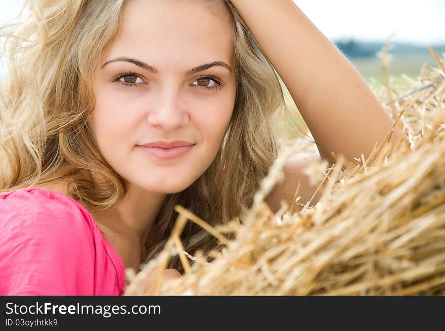 Girl at a stack of straw