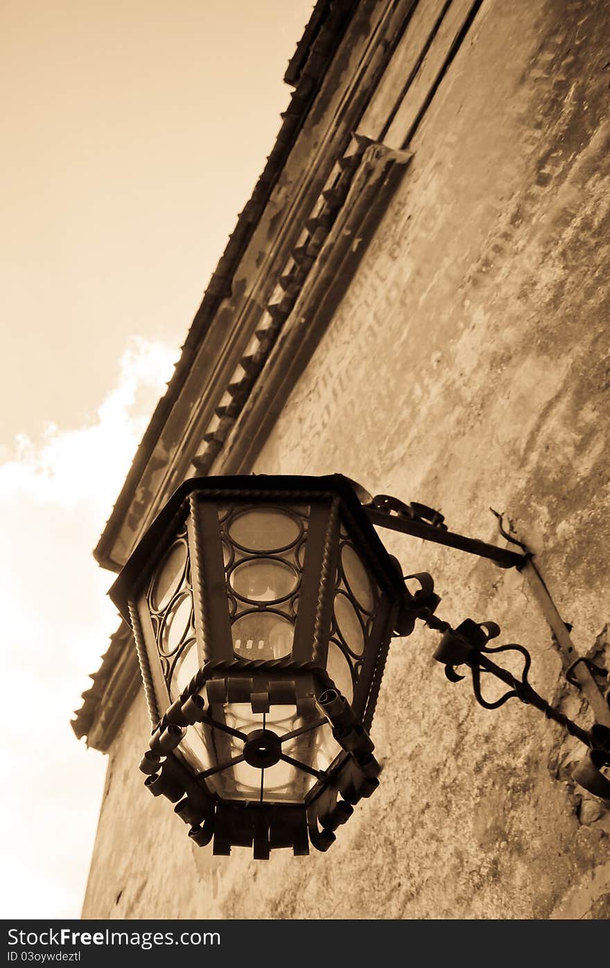 Old styled wall lamp on a medieval castle. Old styled wall lamp on a medieval castle
