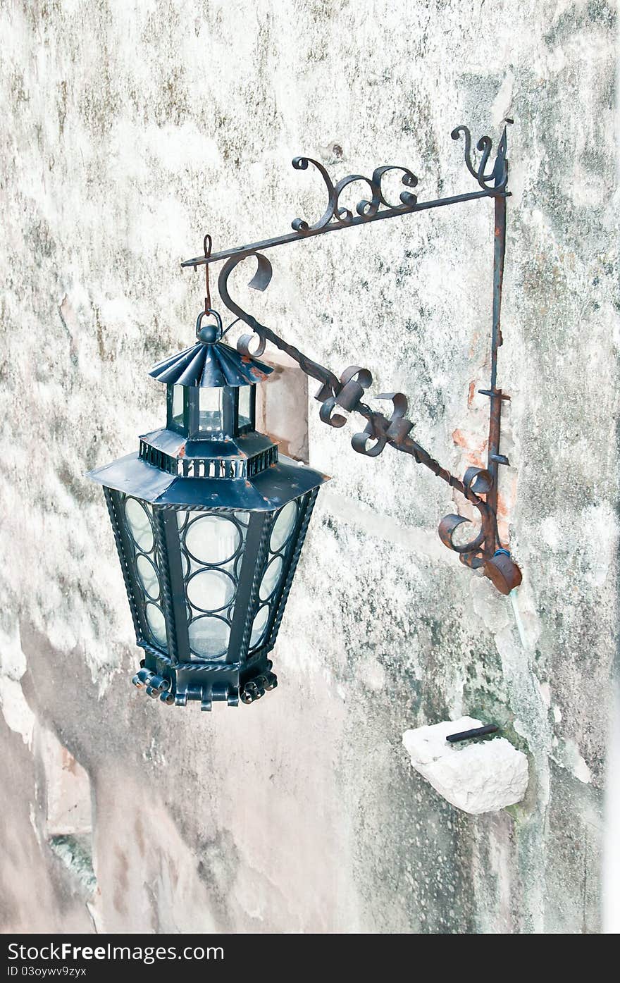 Old styled wall lamp on a medieval castle. Old styled wall lamp on a medieval castle