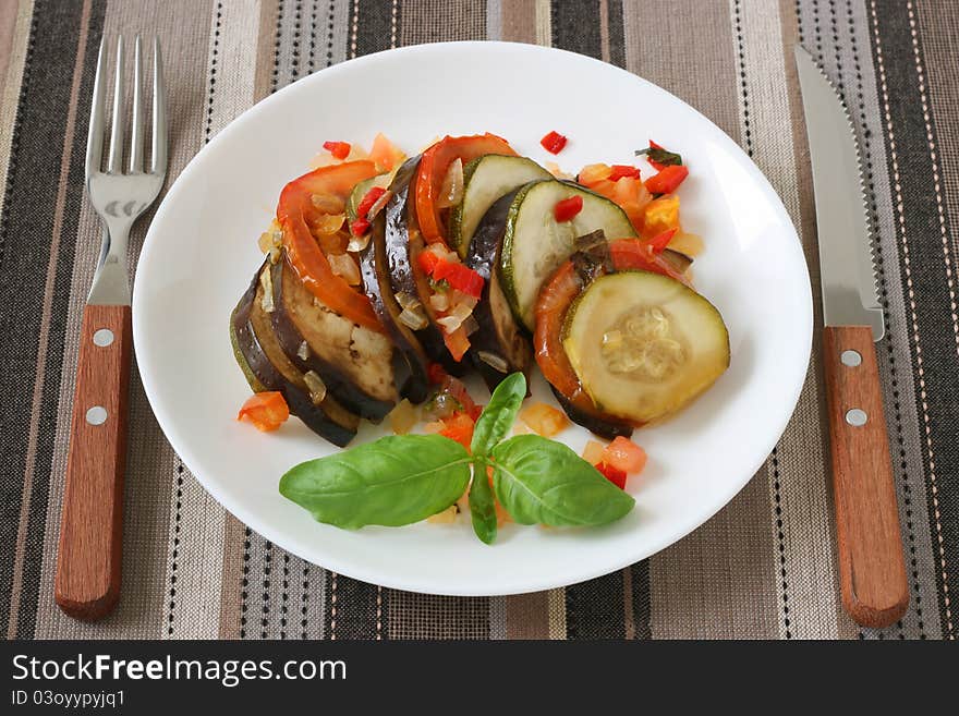 Ratatouille with basil on an white plate