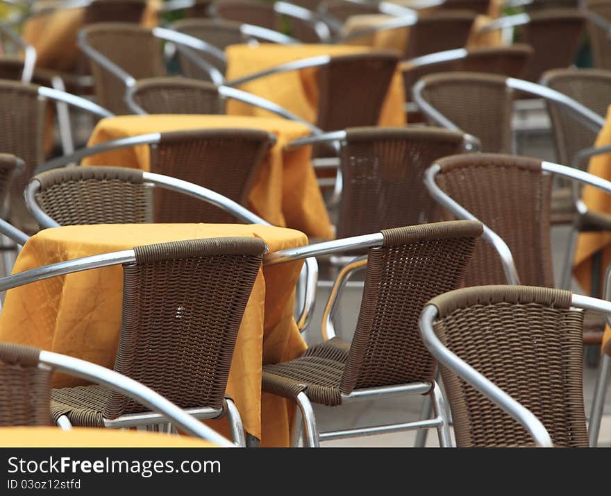 Close up image of many tables on a terrace.