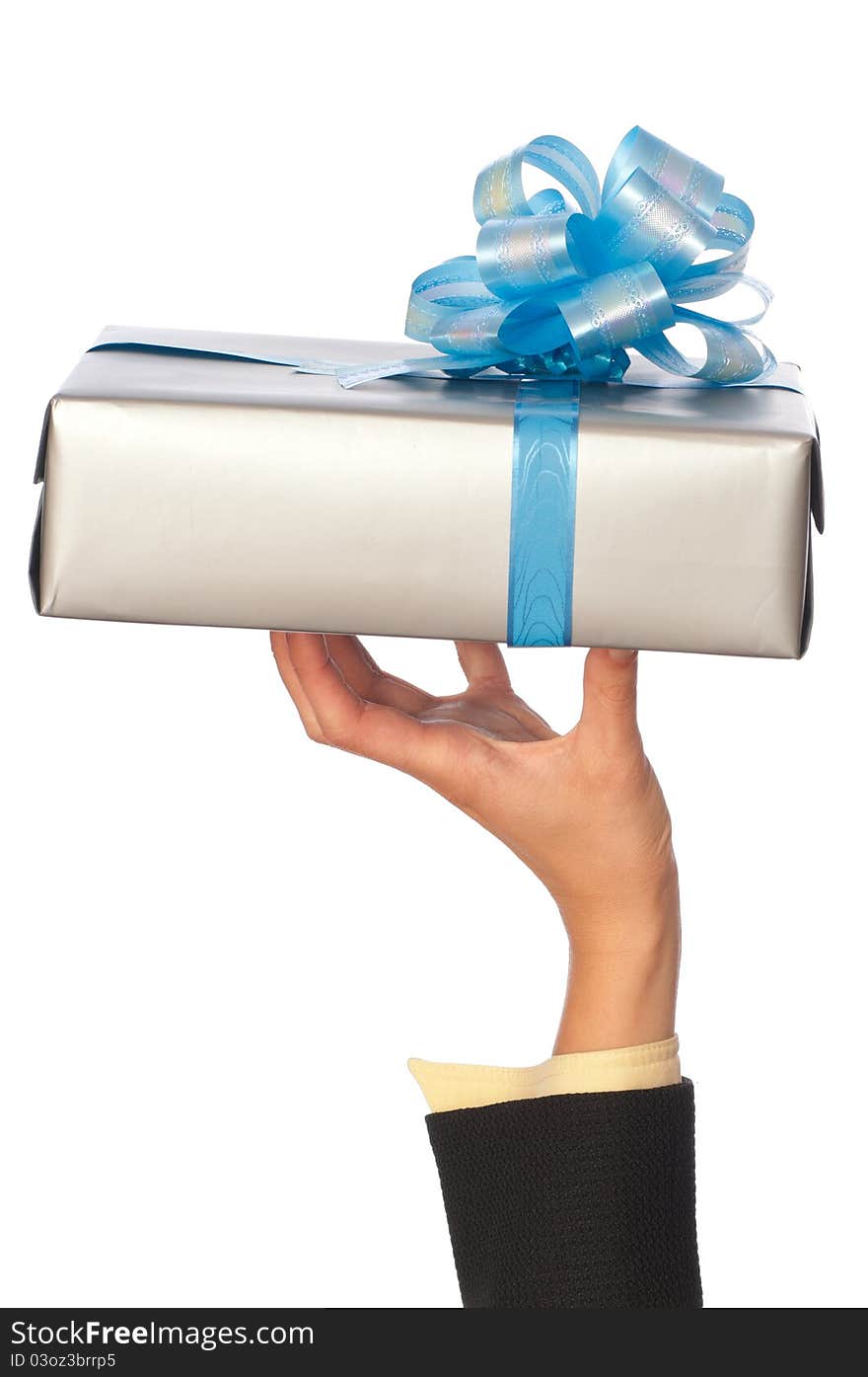 Woman holding a grey box with blue bow as a present. Woman holding a grey box with blue bow as a present