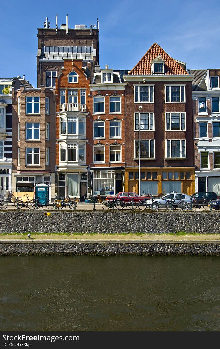 Classic amsterdam view. Residential homes on the canal. Urban scene. Spring.