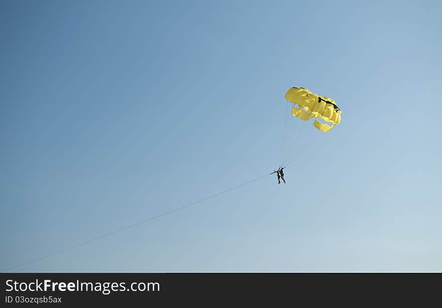 Parachuteon a blue sky in the summer time