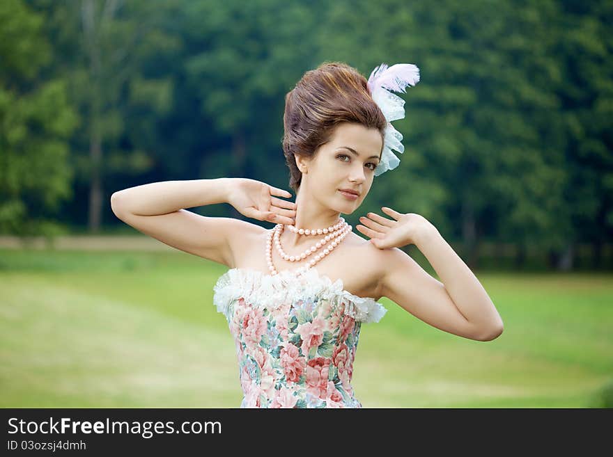 A woman like a princess in an vintage dress in nature