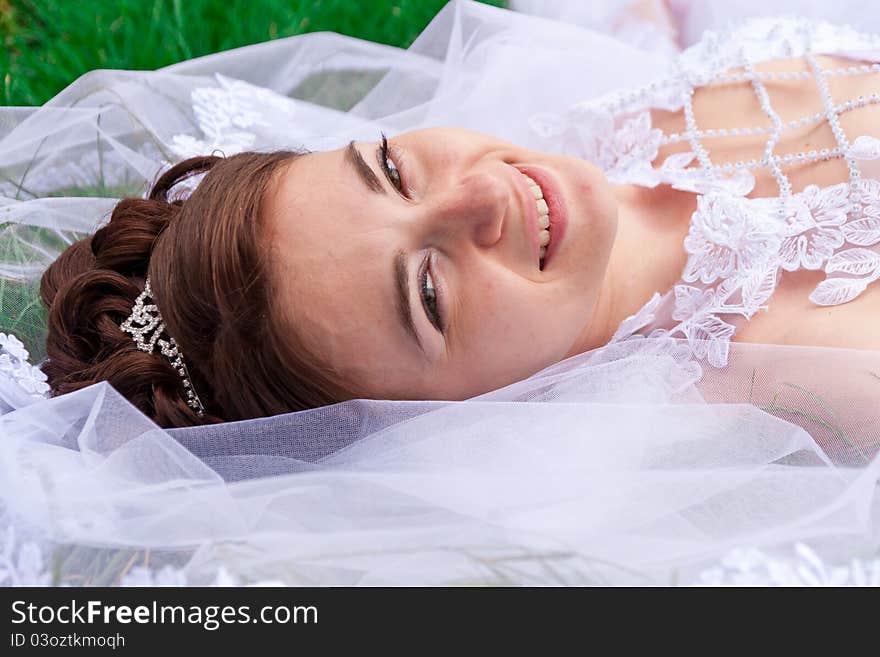 Portrait of a beautiful bride on the grass