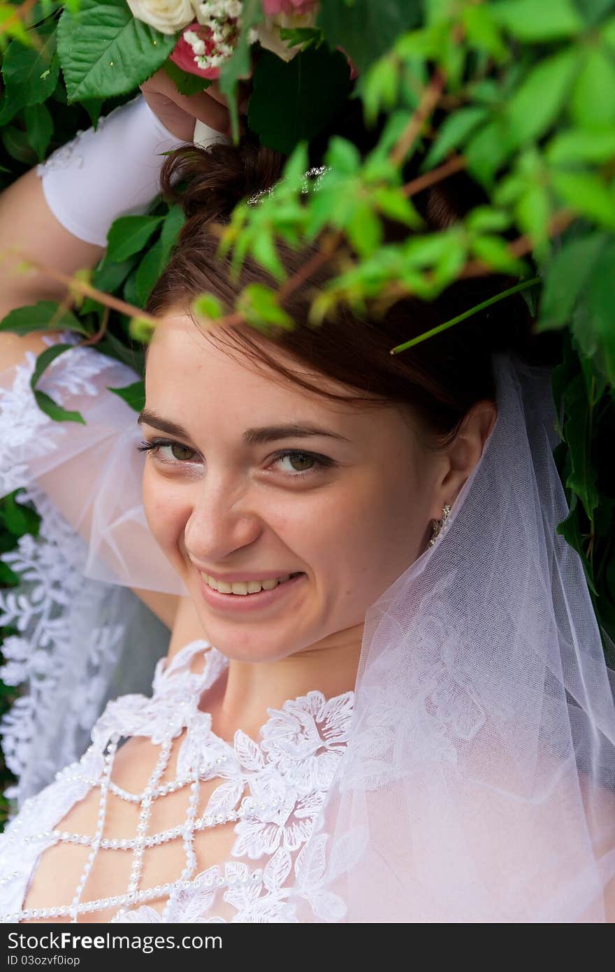 Portrait of a beautiful bride at green wall