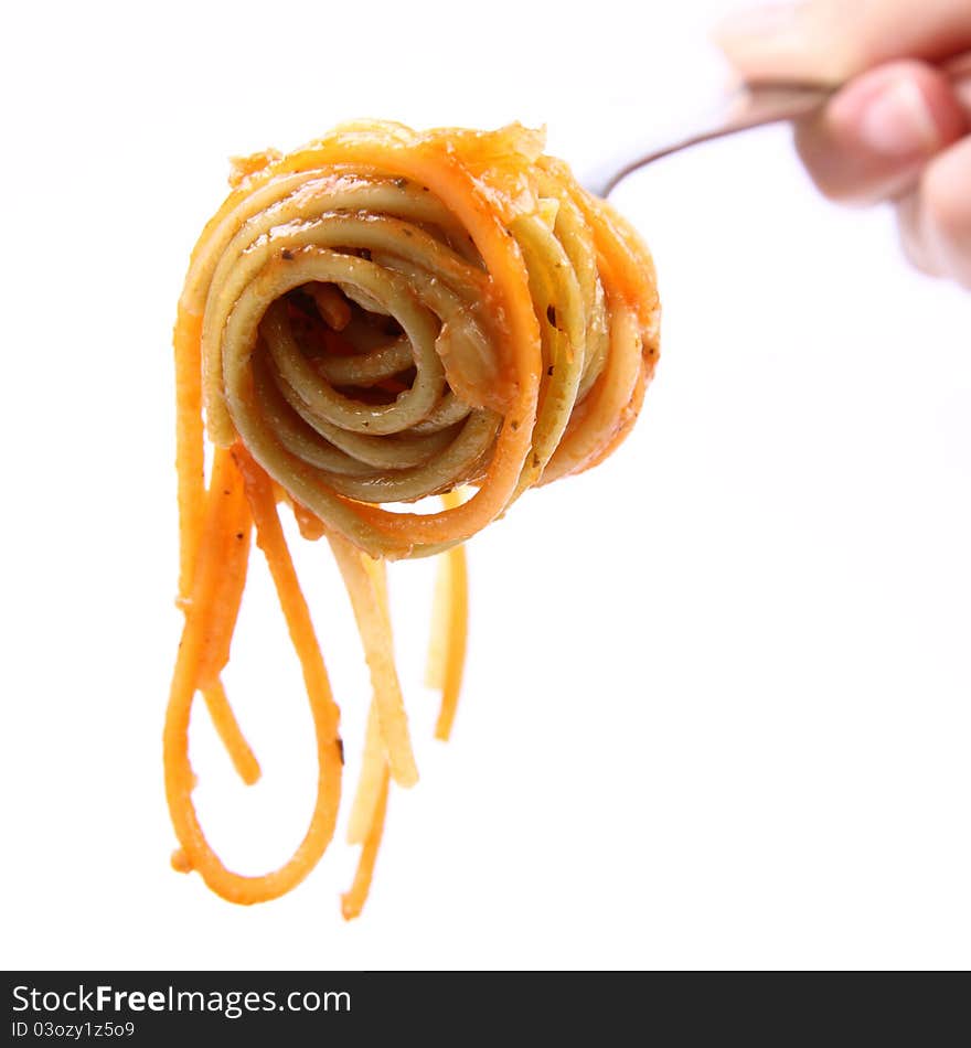 Spaghetti with sauce on a fork held by a woman's hand. Spaghetti with sauce on a fork held by a woman's hand