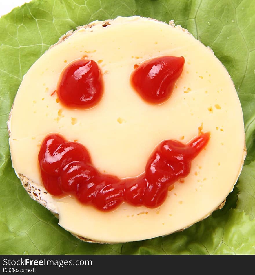 Smiling cheese sandwich for kids on lettuce