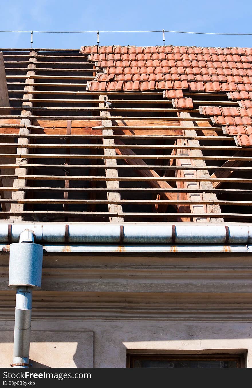 Roof renovation, removing tiles and exposed framework. Roof renovation, removing tiles and exposed framework