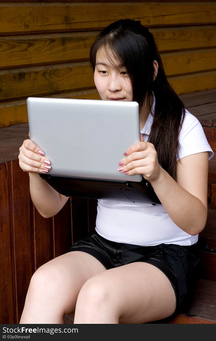 Girl working on laptop outdoor