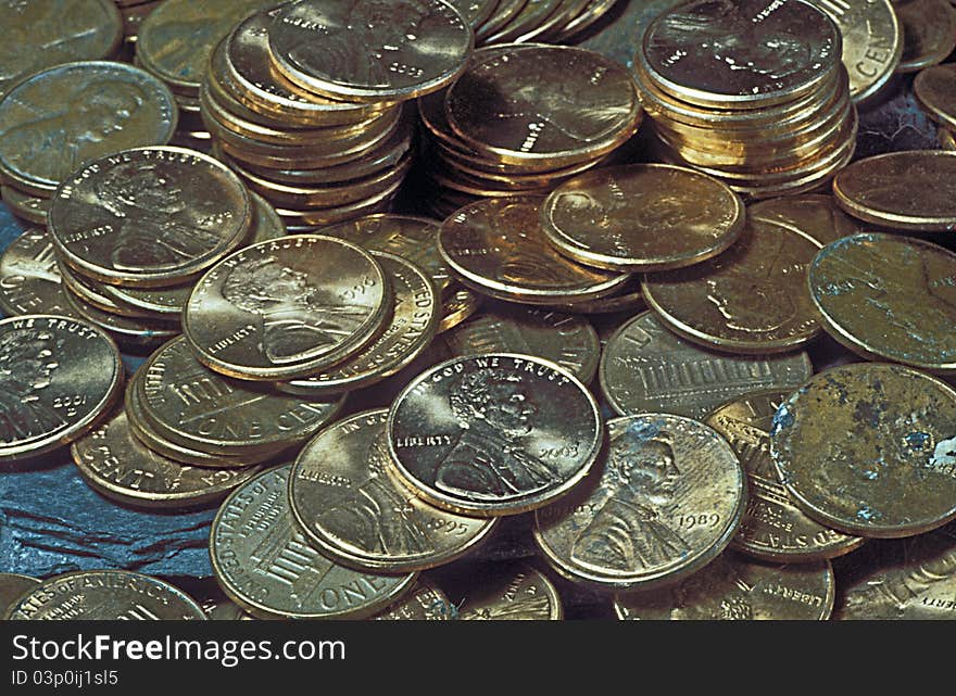 Piles of United States circulated coinage. The pennies have picture of Abraham Lincoln and say In God We Trust. Piles of United States circulated coinage. The pennies have picture of Abraham Lincoln and say In God We Trust.