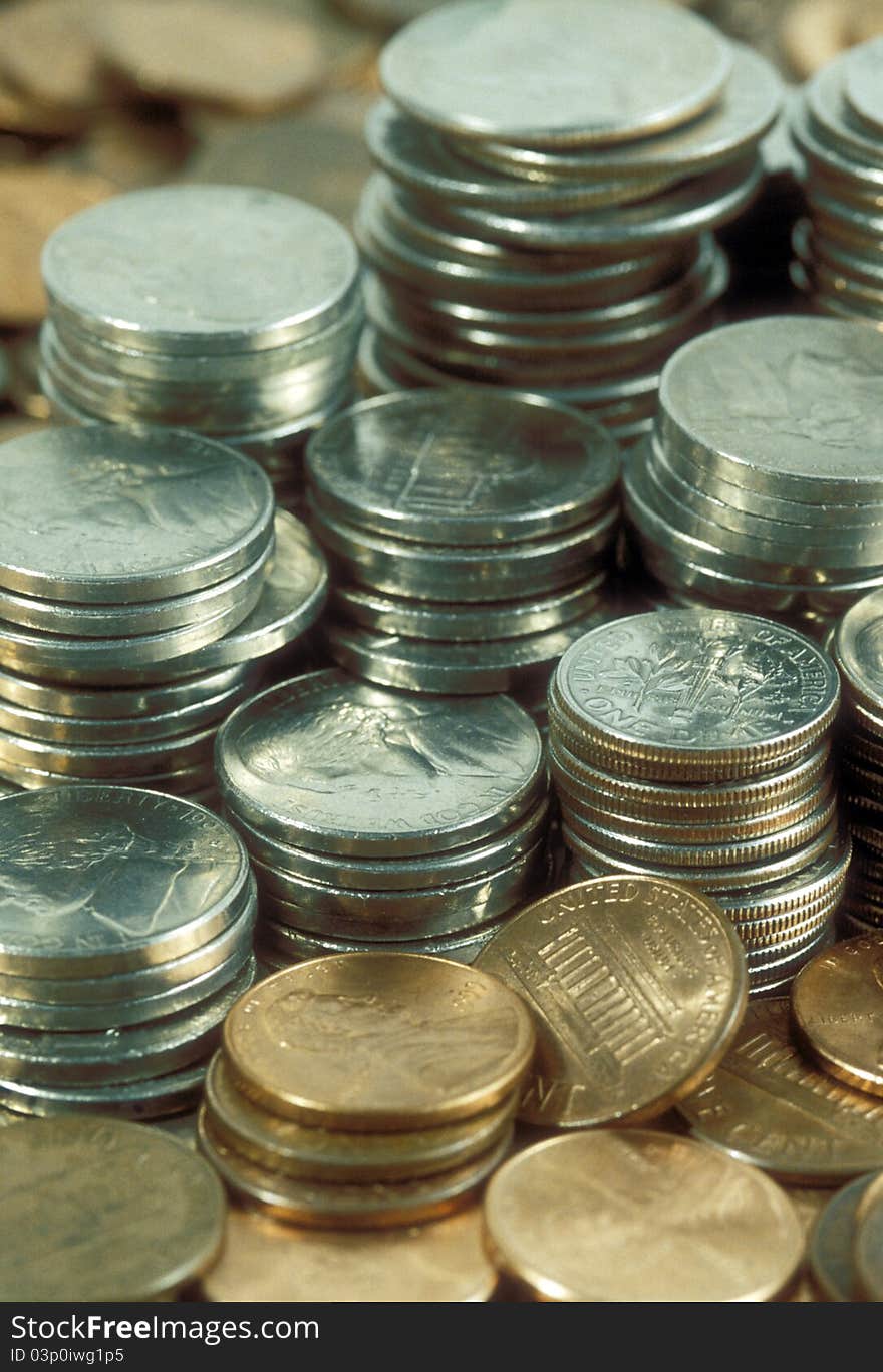 Piles of United States coinage including pennies, nickels, and quarters. Piles of United States coinage including pennies, nickels, and quarters.