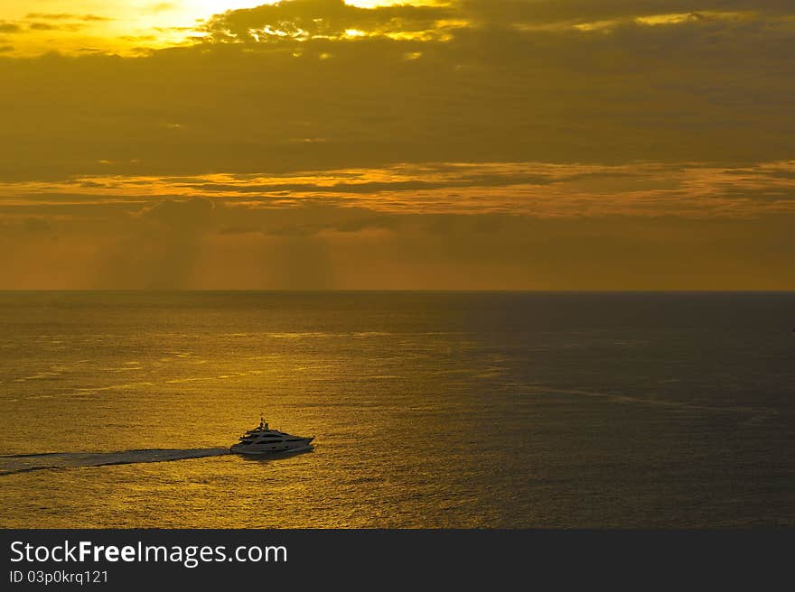 Boat on golden sea, Phromthep cape, Phuket, Thailand