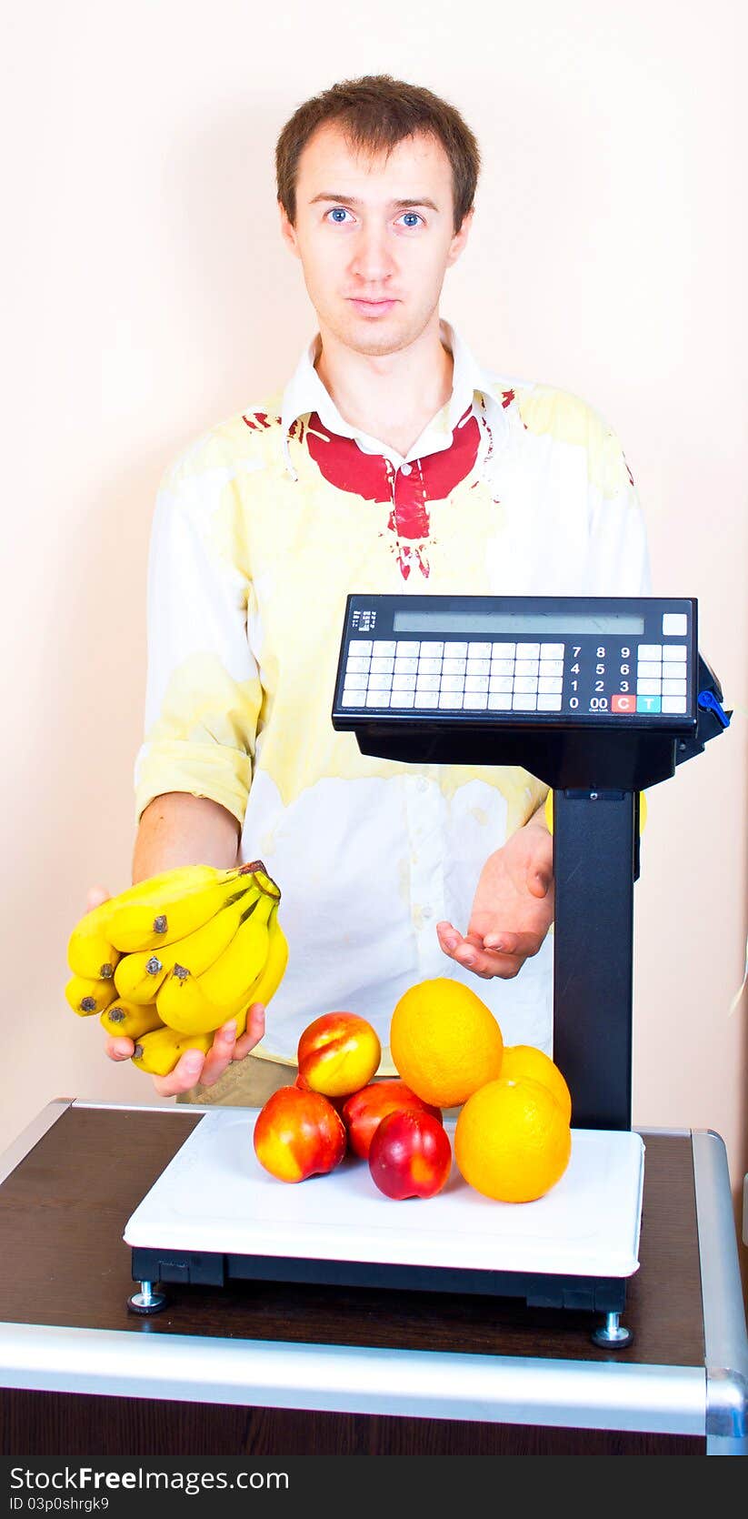 Man weighing fruits at market