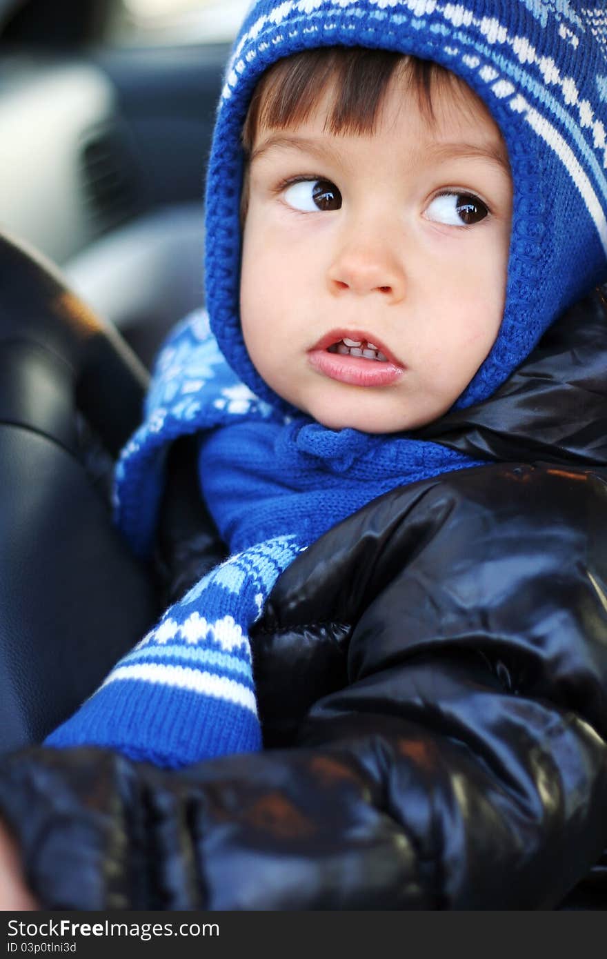 Beautiful little boy driving a car. Beautiful little boy driving a car