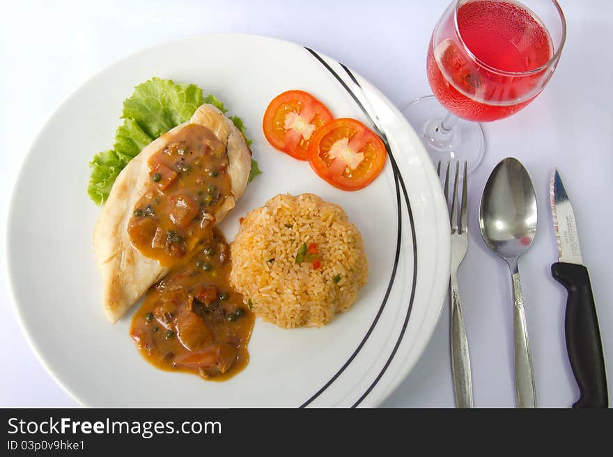 Chicken steak and fried rice with pepper brown sauce and a glass of pink wine. Chicken steak and fried rice with pepper brown sauce and a glass of pink wine