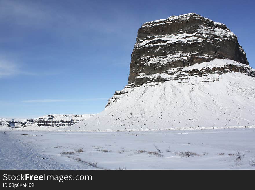 Big rock in an Iceland snow landscape