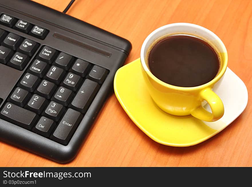 Empty keyboard and coffee cup. Empty keyboard and coffee cup