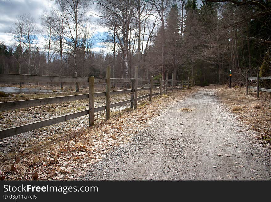 Wooden fence along a gravel path