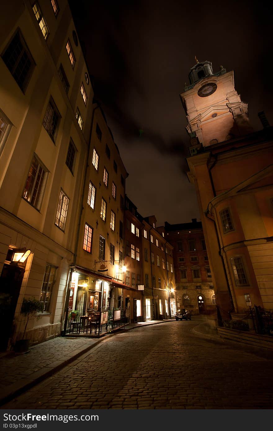 A back alley in Stockholm with a tall church in the background