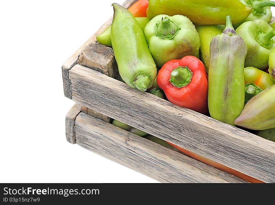 Peppers in a box on the table.