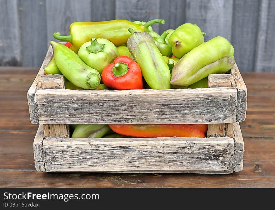 Peppers in a box on the table. Peppers in a box on the table.