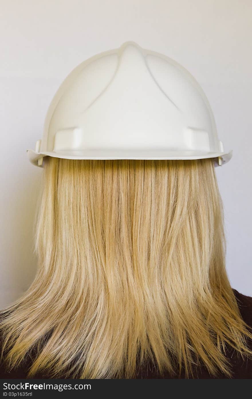 White hard hat reversed on womans head