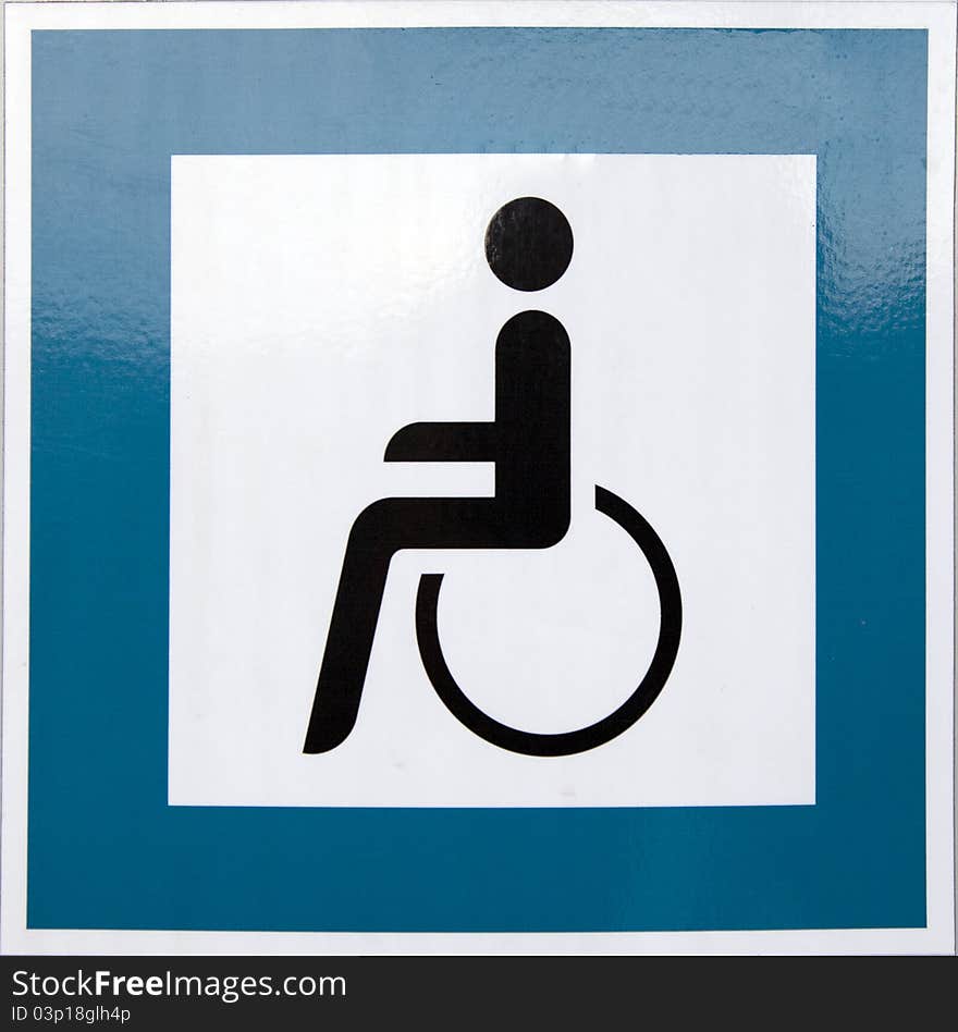 Blue square handicap sign with wheelchair