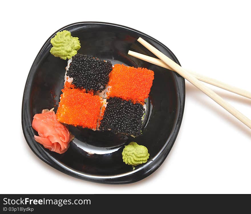 Closeup sushi with chopsticks on black plate