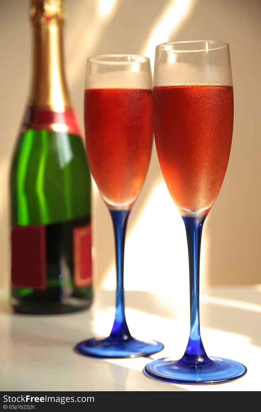 Close-up of champagne in glasses and bottle.