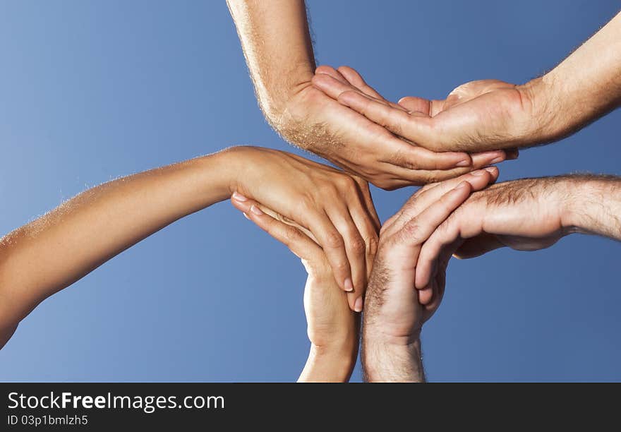 Three persons put their palms together. Three persons put their palms together