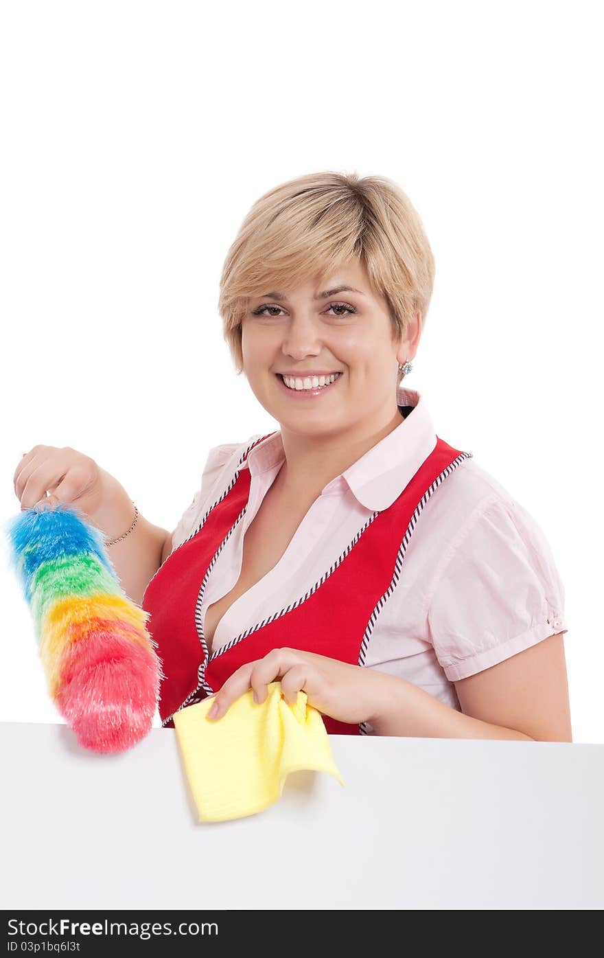 Happy young housewife holding duster - isolated on white background