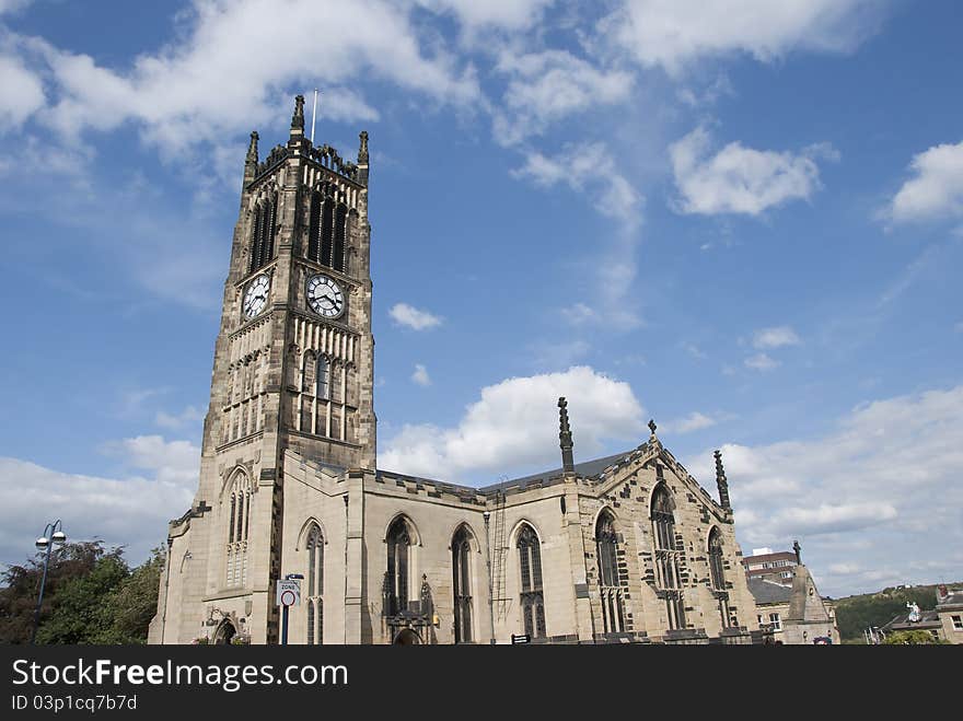 The Parish Church and Clocktower of a Yorkshire Town under a blue sky