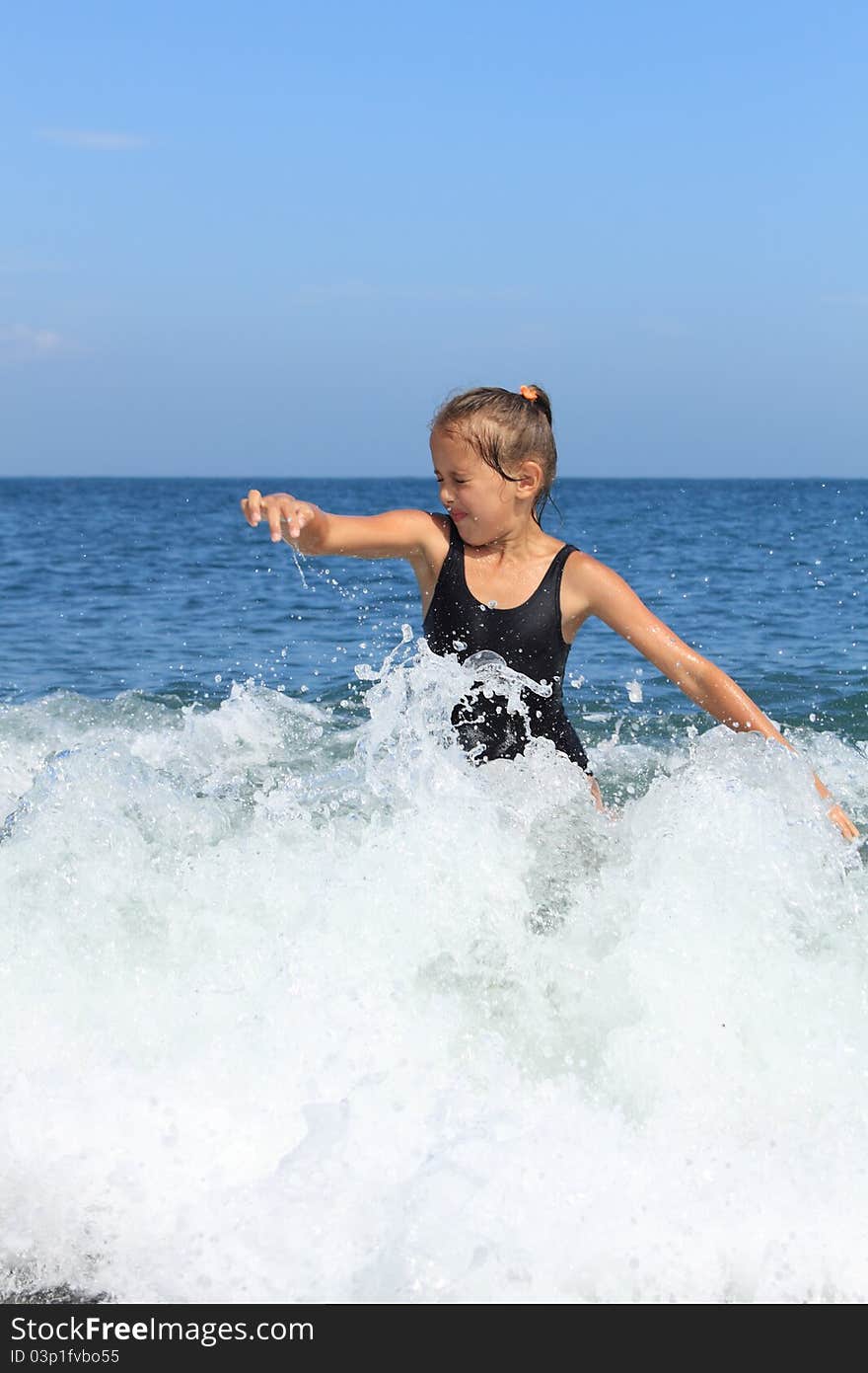 Girl bathes in sea among big waves. Girl bathes in sea among big waves