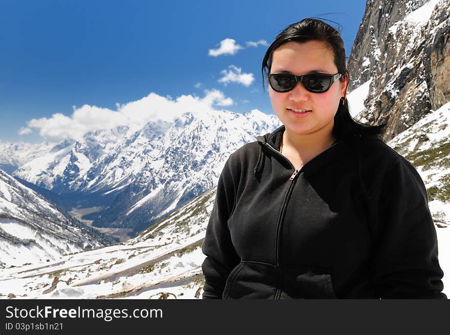 Attractive Sikkimese woman in front of Sikkim landscape at Yumthang valley