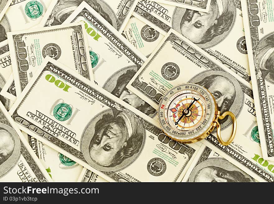 Vintage gold Compass on american money background. Vintage gold Compass on american money background