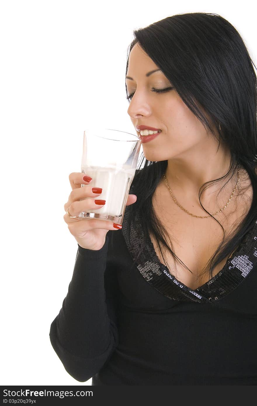 Beautiful young brunette woman holding glass of milk