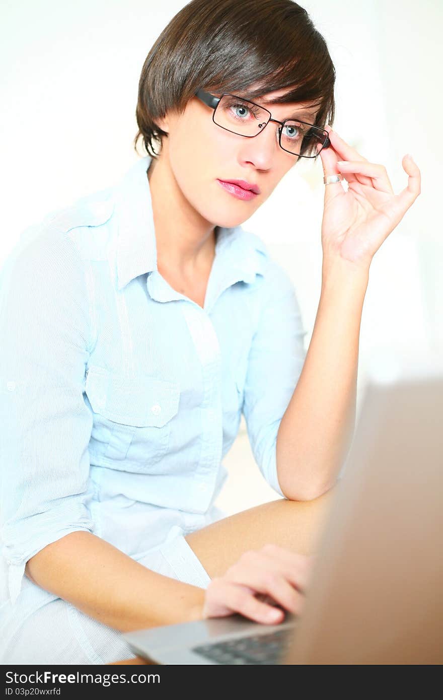 Beautiful girl with glasses working on laptop