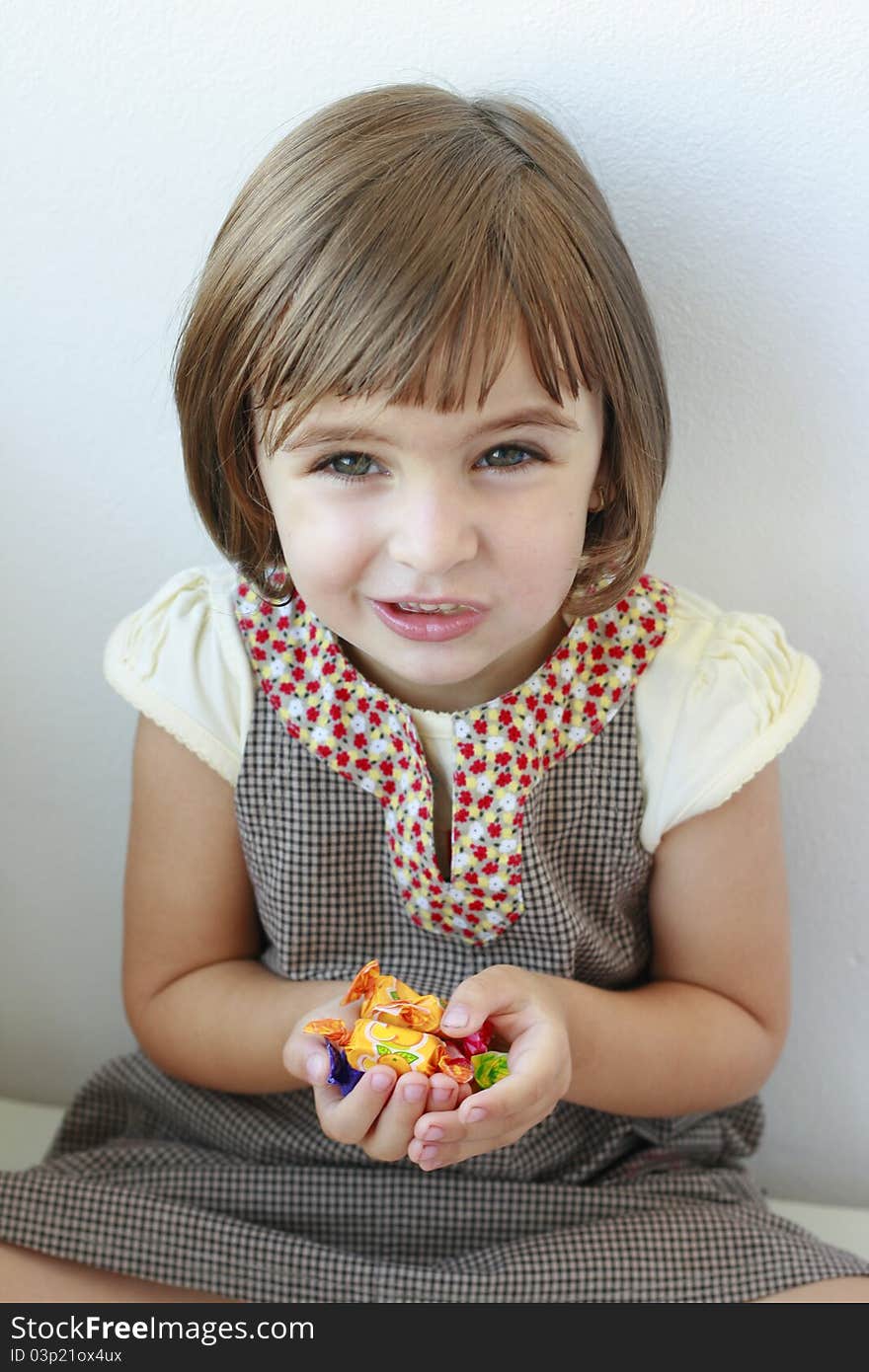 Little girl with candies in her hands