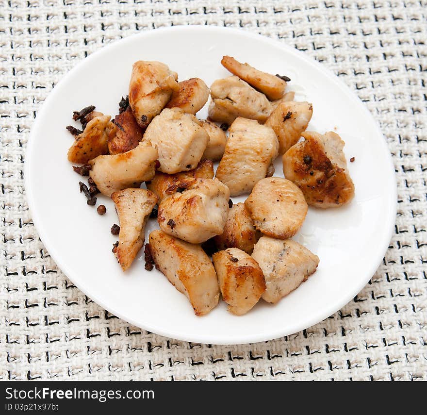 Delicious chicken with potatoes on a white platter