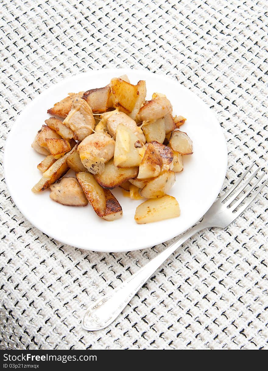 Many pieces of fried chicken well on a white plate on a checkered tablecloth. Many pieces of fried chicken well on a white plate on a checkered tablecloth