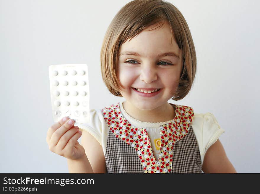 Little girl with medicaments in her hand