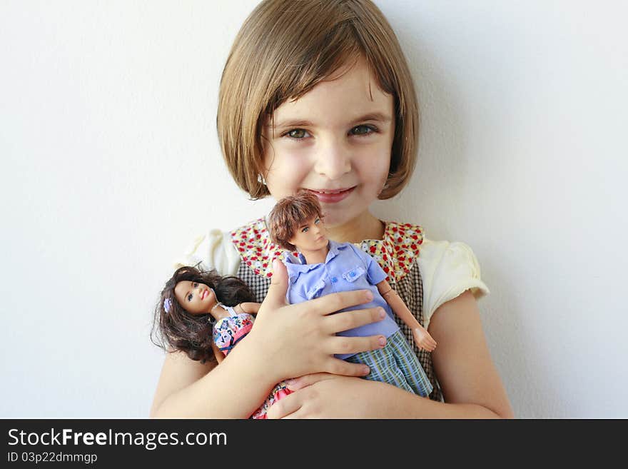 Little girl with two dolls in her arms. Little girl with two dolls in her arms